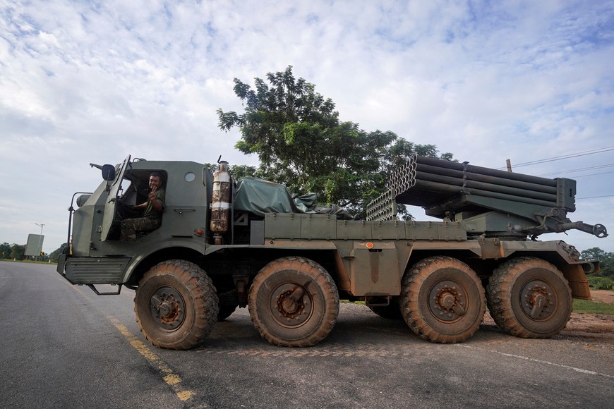 A Cambodian military personnel gestures from a BM-21 Grad multiple rocket launcher, around 40 km (24 miles) from the disputed Ta Moan Thom temple, after Thailand and Cambodia exchanged heavy artillery on Friday as their worst fighting in more than a decade stretched for a second day, in Oddar Meanchey province, Cambodia, July 25, 2025. REUTERS/Soveit Yarn