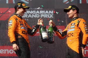 Formula One F1 - Hungarian Grand Prix - Hungaroring, Budapest, Hungary - August 3, 2025
McLaren's Lando Norris celebrates on the podium after winning the Hungarian Grand Prix with second placed McLaren's Oscar Piastri REUTERS/Jakub Porzycki