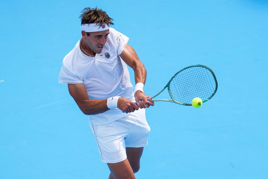 Aug 7, 2025; Cincinnati, OH, USA; Tomas Martín Etcheverry (ARG) returns a shot against Shang Juncheng (CHN) during the Cincinnati Open at the Lindner Family Tennis Center. Mandatory Credit: Aaron Doster-Imagn Images