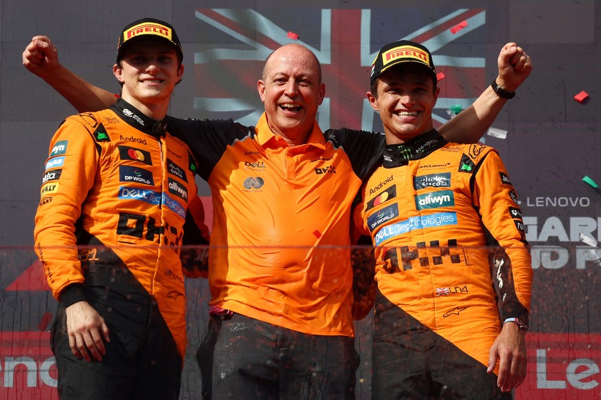 Formula One F1 - Hungarian Grand Prix - Hungaroring, Budapest, Hungary - August 3, 2025
McLaren's Lando Norris celebrates on the podium after winning the Hungarian Grand Prix with second placed McLaren's Oscar Piastri and Mark Ingham, head of design at McLaren REUTERS/Jakub Porzycki