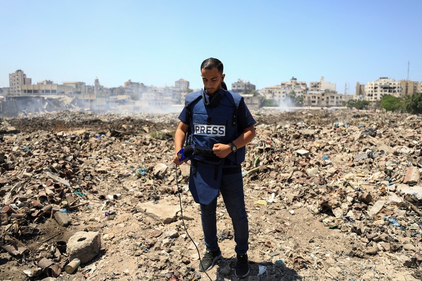 FILE PHOTO: Al Jazeera journalist Anas Al Sharif, who was killed in an Israeli strike on August 10, 2025, stands at a landfill as he reports the news in Gaza City August 13, 2024. REUTERS/Dawoud Abu Alkas/File Photo