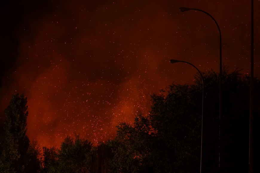 Sparks fly during a wildfire in Tres Cantos, near Madrid, Spain, August 11, 2025. REUTERS/Juan Medina