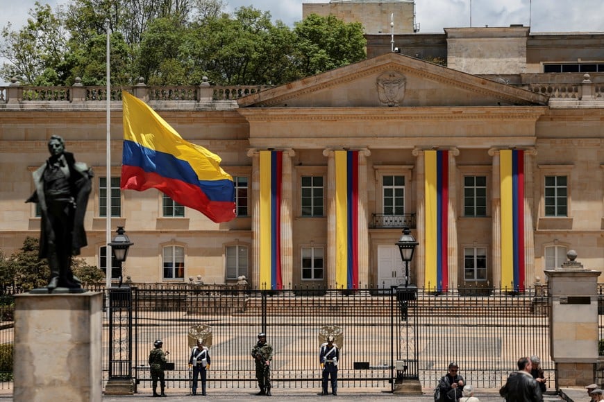A Colombian flag is lowered at half-mast at the Casa de Narino, the presidential residence, after the death of Senator Miguel Uribe Turbay, who was shot in the head at a campaign event on June 7, in Bogota, Colombia, August 11, 2025. REUTERS/Luisa Gonzalez