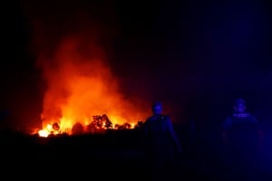 Spanish Civil Guards watch a wildfire on the outskirts of Abejera de Tabara, Zamora, Spain, August 13, 2025. REUTERS/Susana Vera