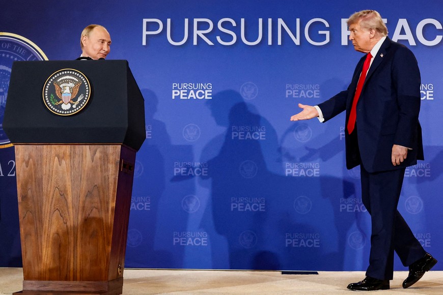 U.S. President Donald Trump walks towards Russian President Vladimir Putin during a press conference following their meeting to negotiate an end to the war in Ukraine, at Joint Base Elmendorf-Richardson, in Anchorage, Alaska, U.S., August 15, 2025. REUTERS/Kevin Lamarque     TPX IMAGES OF THE DAY