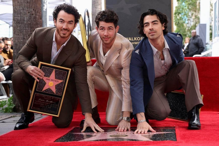 The Jonas Brothers pose during their star unveiling ceremony on The Hollywood Walk of Fame in Los Angeles, California, U.S., January 30, 2023. REUTERS/Mario Anzuoni