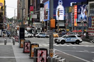 Police vehicles block a street in a cordoned off area in Times Square in New York City, U.S. August 18, 2025. REUTERS/Jeenah Moon