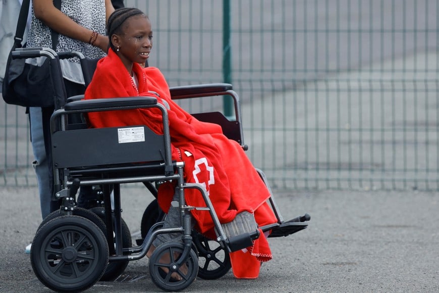 A migrant minor waits in a wheelchair to be assisted by the Red Cross at the port of Arguineguin, on the island of Gran Canaria, Spain, March 28, 2024. REUTERS/Borja Suarez