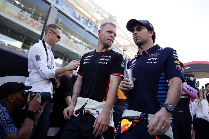 Formula One F1 - Abu Dhabi Grand Prix - Yas Marina Circuit, Abu Dhabi, United Arab Emirates - December 8, 2024
Red Bull's Sergio Perez with Haas' Kevin Magnussen before the race REUTERS/Jakub Porzycki