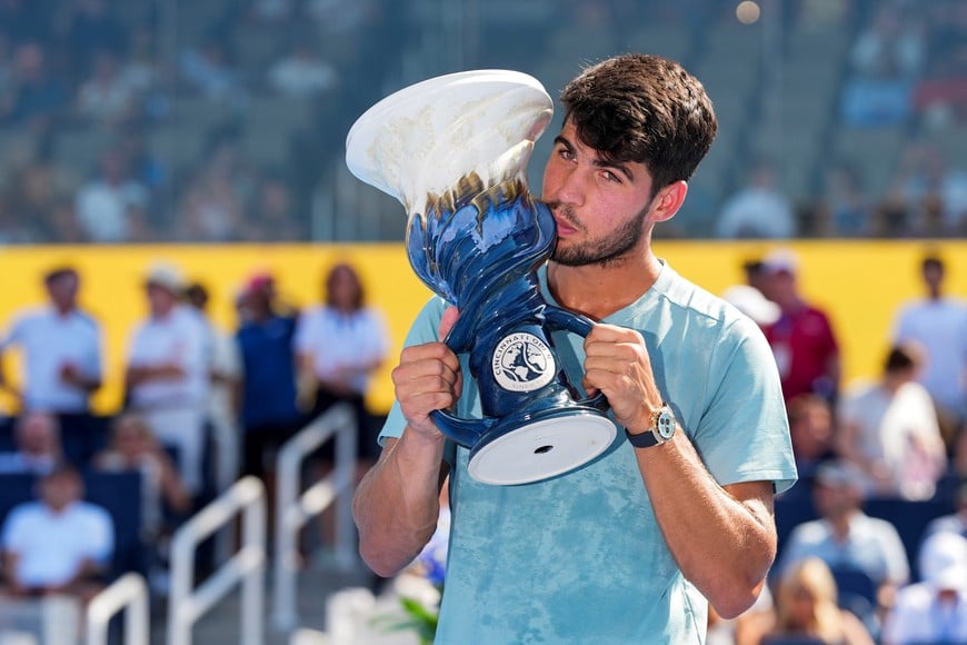 Aug 18, 2025; Cincinnati, OH, USA;  Carlos Alcaraz (ESP) poses for a photo with the Rookwood Cup after his match against Jannik Sinner (ITA) during the Cincinnati Open at the Lindner Family Tennis Center. Mandatory Credit: Aaron Doster-Imagn Images