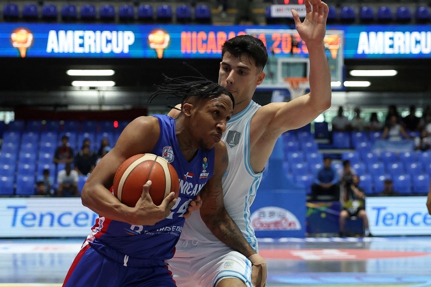 Basketball - FIBA AmeriCup 2025 - Group C - Argentina v Dominican Republic - Polideportivo Alexis Arguello, Managua, Nicaragua - August 24, 2025
Dominican Republic's Jassel Perez in action with Argentina's Gonzalo Corbalan REUTERS/Luisa Gonzalez