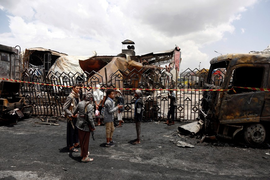 People stand outside a fuel station one day after it was hit by Israeli airstrikes in Sanaa, Yemen, August 25, 2025. REUTERS/Stringer