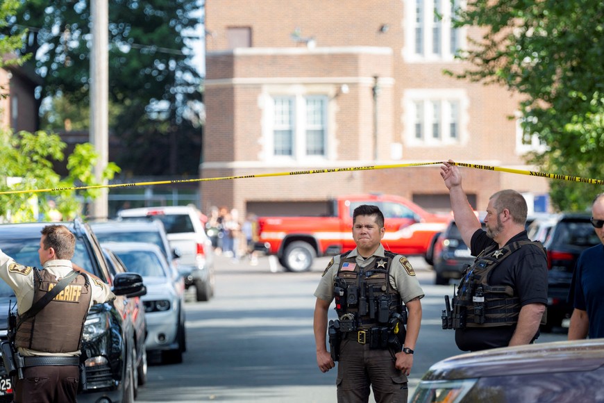 An officer with the Hennepin County Sheriff looks on outside a shooting at Annunciation Church, which is also home to a an elementary school, in Minneapolis, Minnesota, U.S. August 27, 2025. REUTERS/Ben Brewer