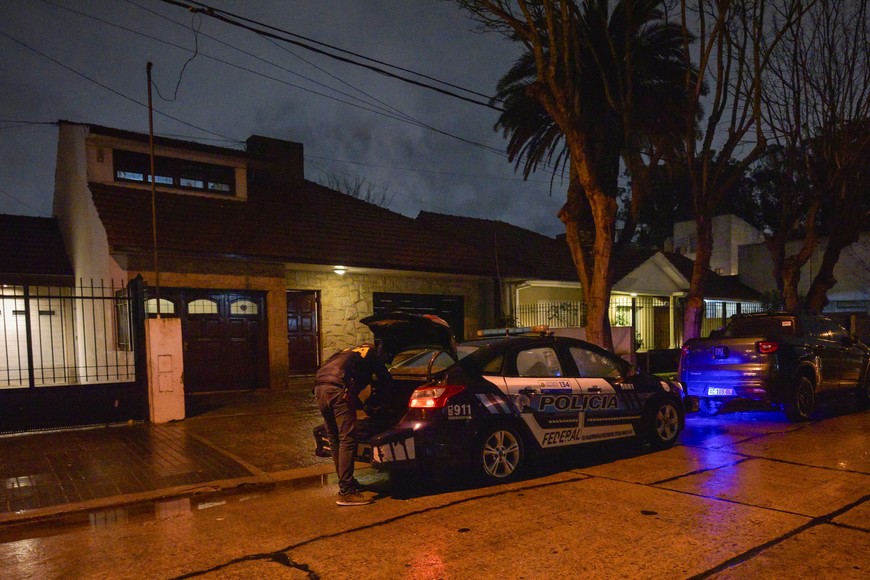 A member of the Argentine Federal Police stands behind a police car, parked outside a house where an Argentine federal court ordered a raid to search for a portrait of Contessa Colleonia, a 17th-century painting by Italian artist Giuseppe Ghislandi, stolen decades ago by the Nazis, after the painting was recently spotted in a real estate listing, in the coastal city of Mar del Plata, Argentina, September 1, 2025. REUTERS/Pilar Subirat