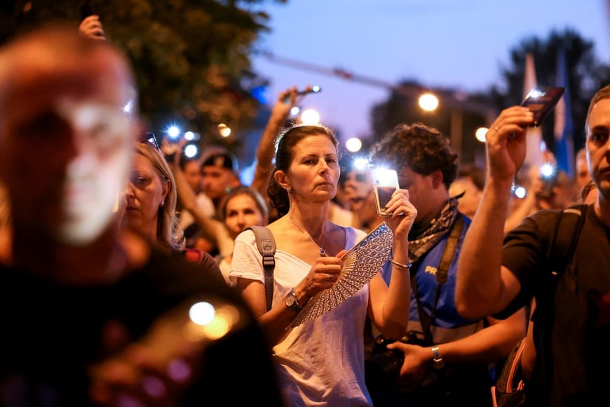 People stand in silence to commemorate the victims killed after a railway concrete canopy fell in November 2024, during a protest against what they say is an increasing police brutality, in Novi Sad, Serbia, September 5, 2025. REUTERS/Zorana Jevtic