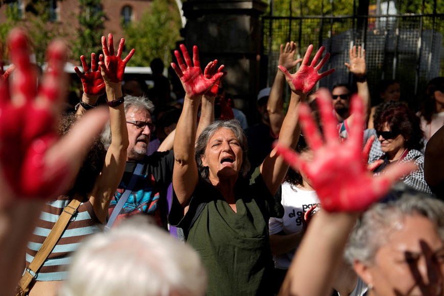 People with hands painted in red demonstrate in support of Global Sumud Flotilla, a humanitarian aid expedition destined for Gaza, in front of Israel embassy in Madrid, Spain, September 6, 2025. REUTERS/Ana Beltran