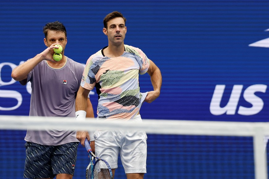 Sep 6, 2025; Flushing, NY, USA; (L-R) Horacio Zeballos (ARG) and Marcel Granollers (ESP) talk between points against Joe Salisbury (GBR) and Neal Skupski (GBR) (both not pictured) in the men's doubles final of the 2025 US Open tennis championships at USTA Billie Jean King National Tennis Center. Mandatory Credit: Geoff Burke-Imagn Images
