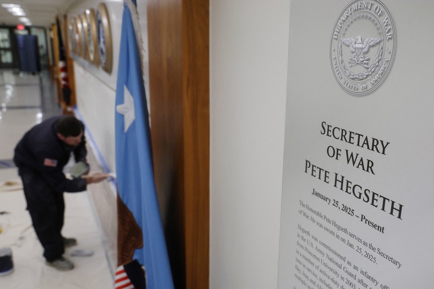 A sign that reads "Pete Hegseth - Secretary of War" hangs as a worker prepares a wall for new signs after U.S. President Donald Trump ordered the Department of Defense to be renamed as the "Department of War," at the Pentagon in Washington, D.C., U.S., September 5, 2025. REUTERS/Jonathan Ernst