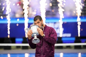 Sep 7, 2025; Flushing, NY, USA;  Carlos Alcaraz (ESP) kisses the trophy after defeating Jannik Sinner (ITA) (not pictured) in the final of mens singles at Billie Jean King National Tennis Center. Mandatory Credit: Robert Deutsch-Imagn Images