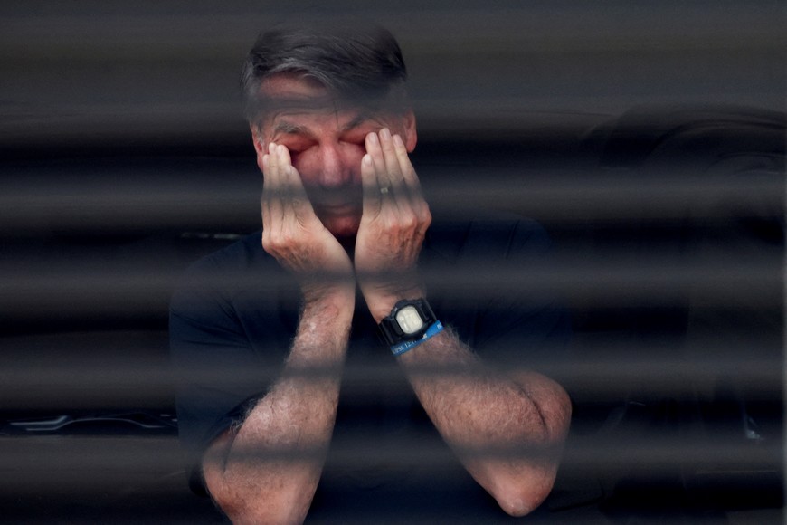 FILE PHOTO: Brazil's former President Jair Bolsonaro covers his eyes at his home while under house arrest, ordered by Supreme Court Justice Alexandre de Moraes, as he awaits trial over an alleged plot to overturn the 2022 election, in Brasília, Brazil, August 14, 2025. REUTERS/Adriano Machado/File Photo