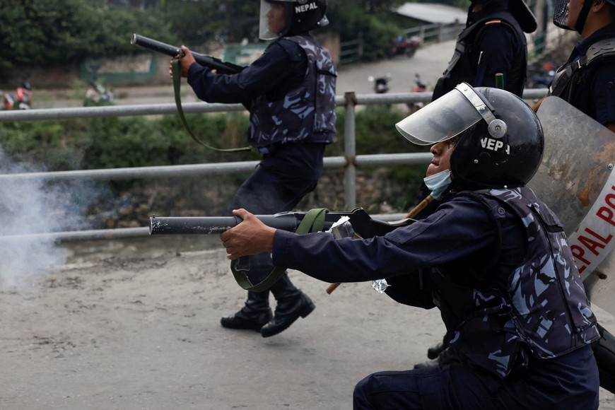 A riot police officer fires teargas towards the demonstrators during a protest against corruption and the government's decision to block several social media platforms, in Kathmandu, Nepal, September 8, 2025. REUTERS/Navesh Chitrakar