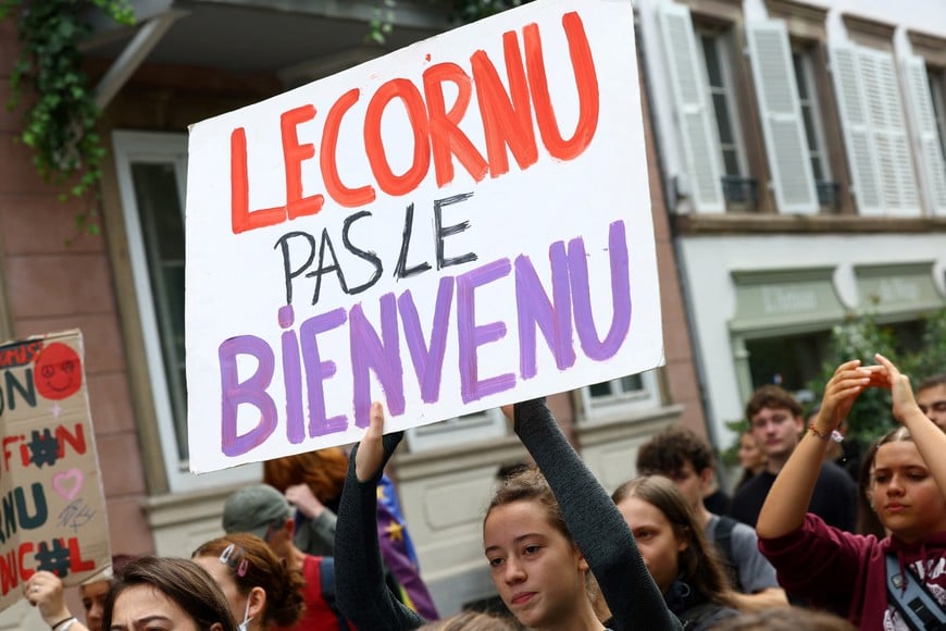 A protester holds a placard which reads "Lecornu, not welcome" during a demonstration in Strasbourg as part of a grassroots protest movement called "Bloquons Tout" ("Let's Block Everything") calling for nationwide all-day disruptions, France, September 10, 2025. REUTERS/Yves Herman
