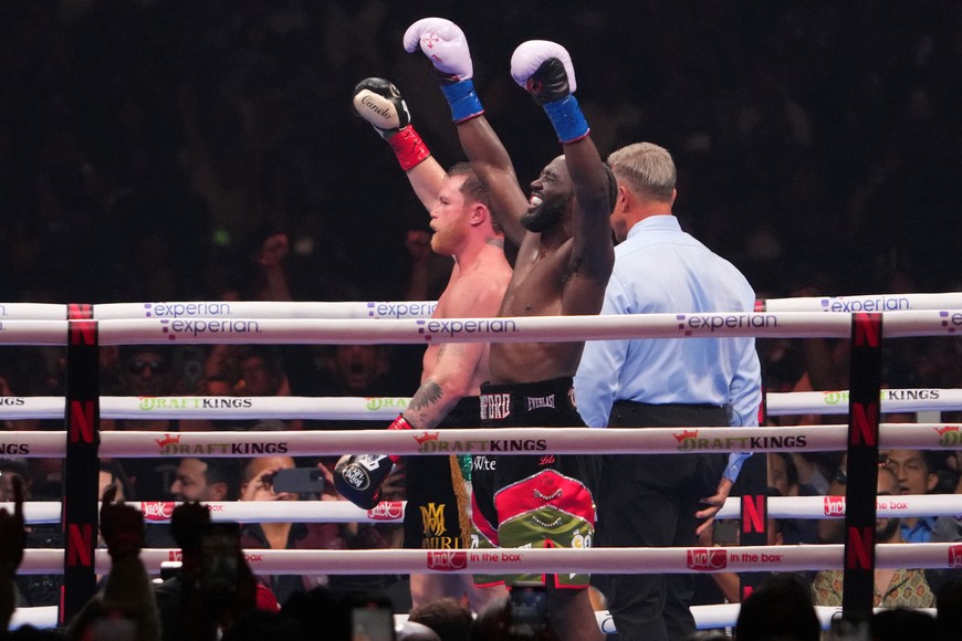 Sep 13, 2025; Las Vegas, Nevada, USA; Canelo Alvarez (black/gold trunks) and Terence Crawford (black/red trunks) react after their super middleweight title bout  at Allegiant Stadium. Mandatory Credit: Joe Camporeale-Imagn Images