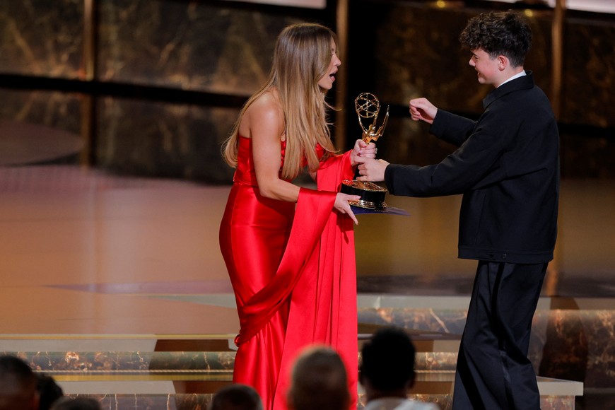 Owen Cooper accepts the award for Outstanding Supporting Actor in a Limited or Anthology Series or Movie for "Adolescence" from presenter Sydney Sweeney at the 77th Primetime Emmy Awards in Los Angeles, California, U.S., September 14, 2025. REUTERS/Mike Blake