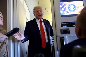 FILE PHOTO: U.S. President Donald Trump speaks to reporters aboard Air Force One on his return from a state visit in Britain, September 18, 2025. REUTERS/Kevin Lamarque/File Photo/File Photo