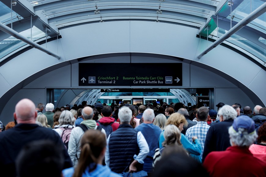 People queue to enter at Dublin Airport's Terminal 2, which has been evacuated as a safety precaution, in Dublin, Ireland, September 20, 2025. REUTERS/Clodagh Kilcoyne