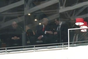 A still image from video shows U.S. President Donald Trump and Tesla CEO Elon Musk shaking hands in a skybox at State Farm Stadium during the memorial service for slain conservative commentator Charlie Kirk, in Glendale, Arizona, U.S., September 21, 2025.  Reuters TV via REUTERS