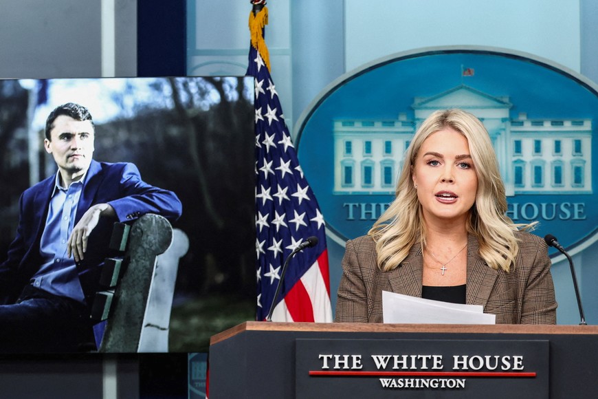 White House press secretary Karoline Leavitt speaks to reporters about the killing of conservative commentator Charlie Kirk as images of him are displayed during a briefing in Washington, D.C., U.S., September 22, 2025. REUTERS/Kevin Lamarque     TPX IMAGES OF THE DAY