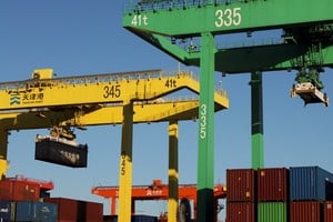 FILE PHOTO: A gantry crane lifts a container at a port in Tianjin, China February 8, 2025. REUTERS/Florence Lo/File Photo