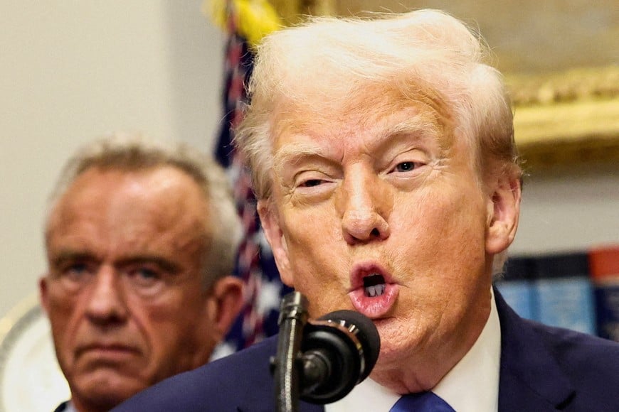 FILE PHOTO: U.S. President Donald Trump, in front of U.S. Secretary of Health and Human Services Robert F. Kennedy Jr., delivers remarks linking autism to childhood vaccines and to the use of popular pain medication Tylenol for pregnant women and children, claims which are not backed by decades of science, at the White House in Washington, D.C., U.S., September 22, 2025. REUTERS/Kevin Lamarque/File Photo