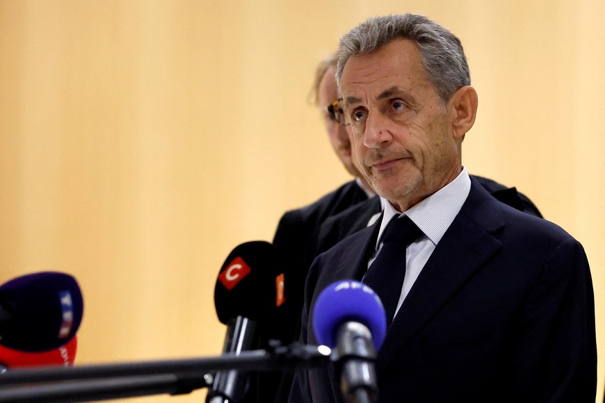 Former French President Nicolas Sarkozy talks to journalists after the verdict in his trial with other defendants on charges of corruption and illegal financing of an election campaign related to alleged Libyan funding of his successful 2007 presidential bid, at the courthouse in Paris, France, September 25, 2025. REUTERS/Stephanie Lecocq