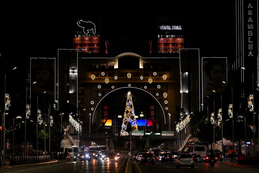 Cars drive on a road adorned with Christmas decorations as the holiday season officially begins since  Venezuela's President Nicolas Maduro announced that Christmas celebrations would start in October, two months ahead of the traditional season, in Caracas, Venezuela October 1, 2025. REUTERS/Gaby Oraa