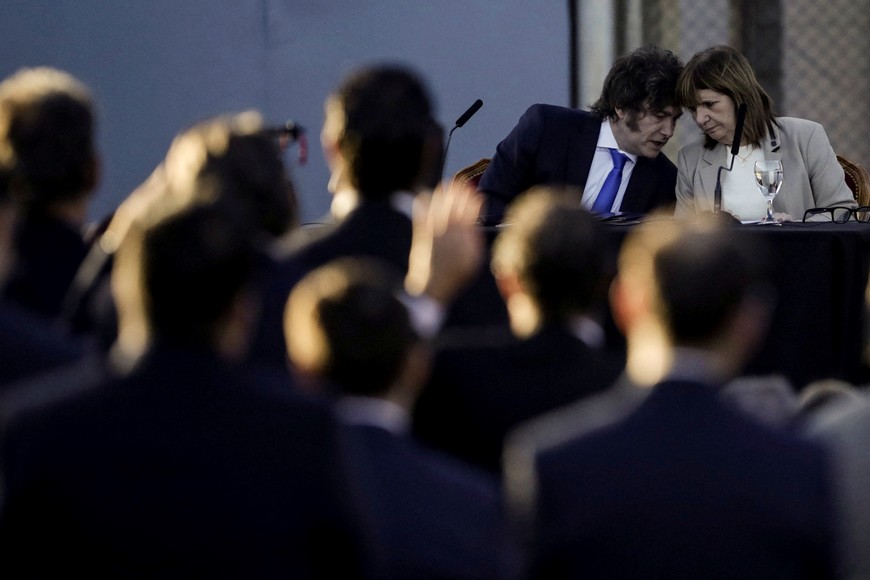 Argentina's President Javier Milei, speaks to Security Minister Patricia Bullrich, as he presents a new Penal Code at the Federal Penitentiary Complex I in Ezeiza, on the outskirts of Buenos Aires, Argentina, Argentina October 2, 2025. REUTERS/Alessia Maccioni