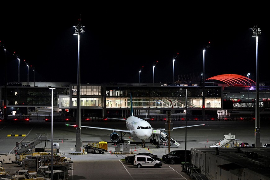An airplane is parked at the airport in Munich, Germany, October 4, 2025, after both runways were closed on Friday evening for the second time in less than 24 hours, with the captain on an aircraft whose departure was canceled telling passengers that drones had once again been sighted. REUTERS/Angelika Warmuth