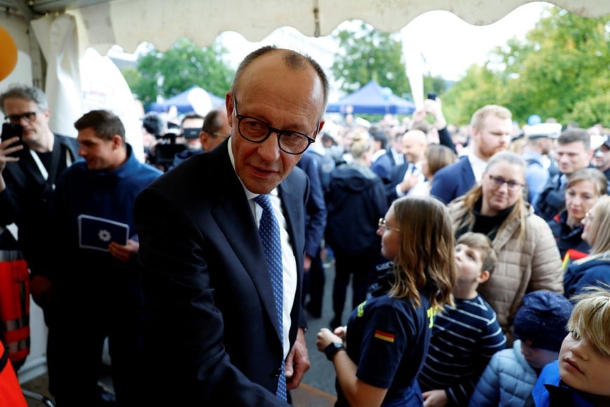 German Chancellor Friedrich Merz meets with people, on the day of the celebrations to mark the 35th anniversary of Germany's Unification Day, in Saarbruecken, Germany, October 3, 2025. REUTERS/Heiko Becker
