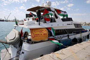 FILE PHOTO: People gather on a boat from a flotilla that had been carrying aid to Gaza until it was intercepted by Israel, docked in the port of Larnaca, Cyprus October 3, 2025. REUTERS/Yiannis Kourtoglou/File Photo