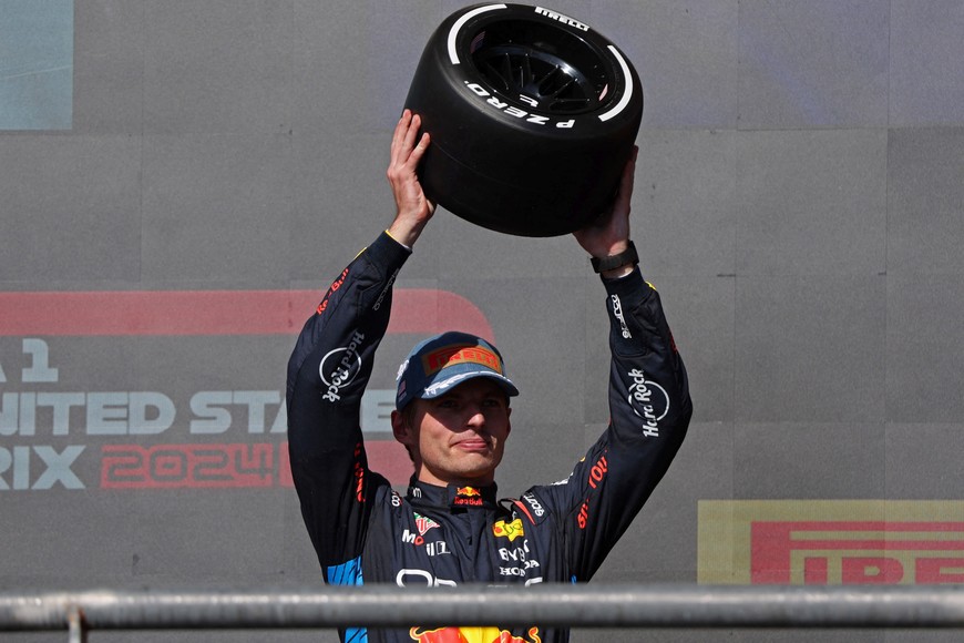 Formula One F1 - United States Grand Prix - Circuit of the Americas, Austin, Texas, United States - October 20, 2024
Red Bull's Max Verstappen celebrates on the podium with a trophy after finishing third REUTERS/Kaylee Greenlee Beal