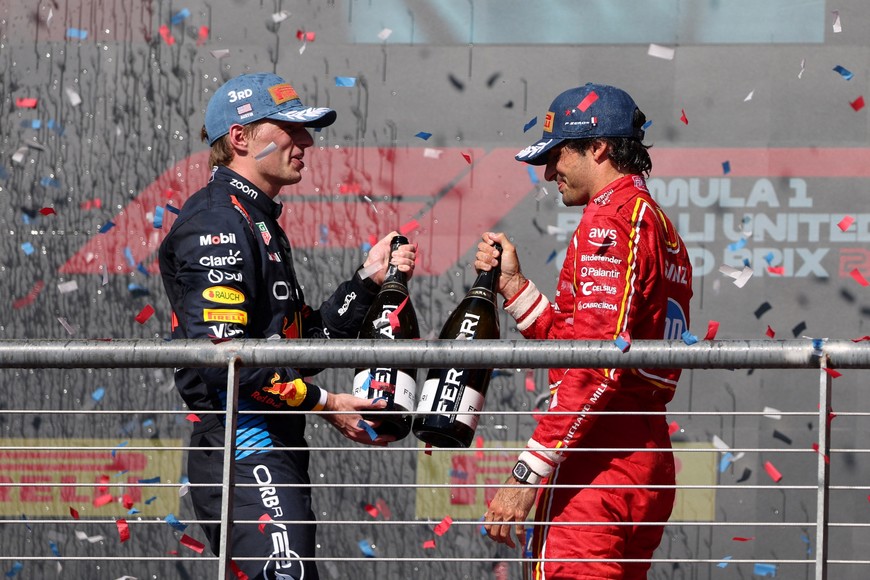 Formula One F1 - United States Grand Prix - Circuit of the Americas, Austin, Texas, United States - October 20, 2024
Ferrari's Carlos Sainz Jr. celebrates second place on the podium with third placed Red Bull's Max Verstappen after the United States Grand Prix REUTERS/Kaylee Greenlee Beal