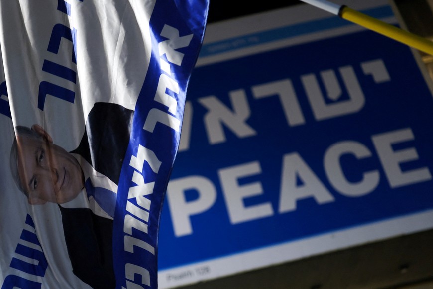 A flag with an image of Israel's Prime Minister Benjamin Netanyahu at "Hostages Square", amid a ceasefire between Israel and Hamas in Gaza, in Tel Aviv, Israel, October 12, 2025. REUTERS/Hannah McKay