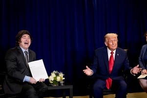 FILE PHOTO: U.S. President Donald Trump and Argentina's President Javier Milei react as they meet during the 80th United Nations General Assembly, in New York City, New York, U.S., September 23, 2025. REUTERS/Al Drago/File Photo