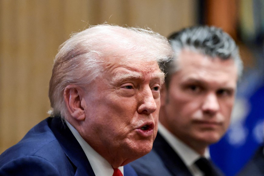 FILE PHOTO: U.S. President Donald Trump and Defense Secretary Pete Hegseth attend a cabinet meeting at the White House, in Washington, D.C., U.S., October 9, 2025. REUTERS/Evelyn Hockstein/File Photo