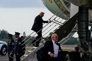U.S. President Donald Trump boards Air Force One as he departs for travel back to Washington at Palm Beach International Airport in West Palm Beach, Florida, U.S., October 19, 2025. REUTERS/Elizabeth Frantz