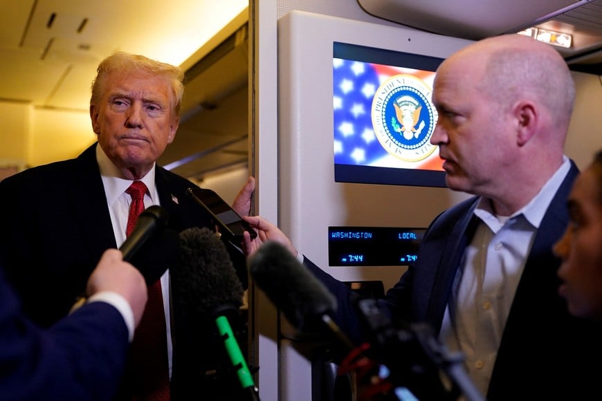 U.S. President Donald Trump speaks to members of the media as he flies from Florida to Washington, aboard Air Force One, U.S., October 19, 2025. REUTERS/Elizabeth Frantz
