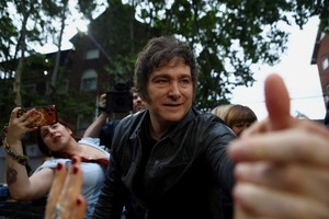 Argentina's President Javier Milei greets supporters during a La Libertad Avanza party rally ahead of the October 26 midterm elections, seen as crucial for his administration after U.S. President Donald Trump warned that future support for Argentina would depend on Milei's party performing well in the vote, in Tres de Febrero, on the outskirts of Buenos Aires, Argentina, October 17, 2025. REUTERS/Matias Baglietto