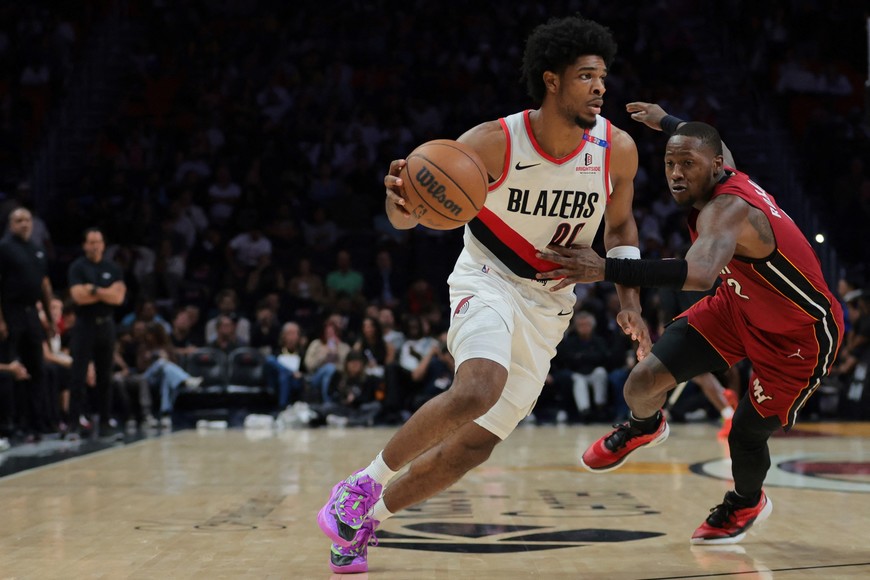 Jan 21, 2025; Miami, Florida, USA; Portland Trail Blazers guard Scoot Henderson (00) drives to the basket past Miami Heat guard Terry Rozier (2) during the third quarter at Kaseya Center. Mandatory Credit: Sam Navarro-Imagn Images