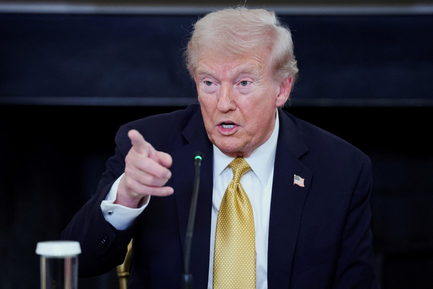 U.S. President Donald Trump gestures during an announcement regarding his administration's policies against cartels and human trafficking, from the State Dining Room at the White House in Washington, D.C., U.S., October 23, 2025. REUTERS/Jonathan Ernst